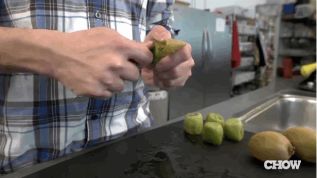 Man in Plaid Shirt Peeling Kiwi