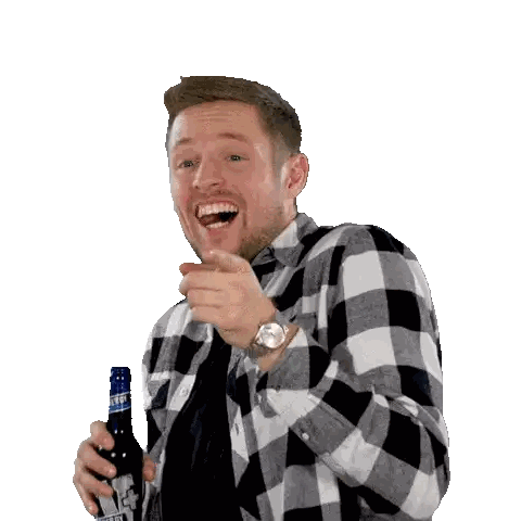 Man In Plaid Shirt Pointing At Camera With Beer Bottle