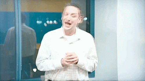 Man in Plaid Shirt Screaming in Front of Window