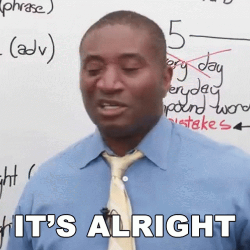 Man in Plaid Shirt Sitting at Desk