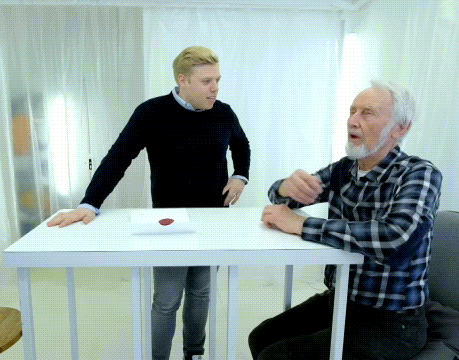 Man in Plaid Shirt Sitting at Table