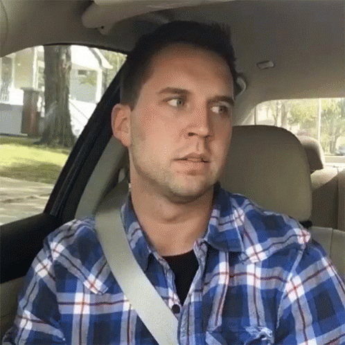 Man In Plaid Shirt Sitting In Car With Seat Belt GIF