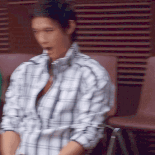 Man in Plaid Shirt Sitting on Chair