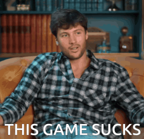Man in Plaid Shirt Sitting on Couch Saying This Game Sucks