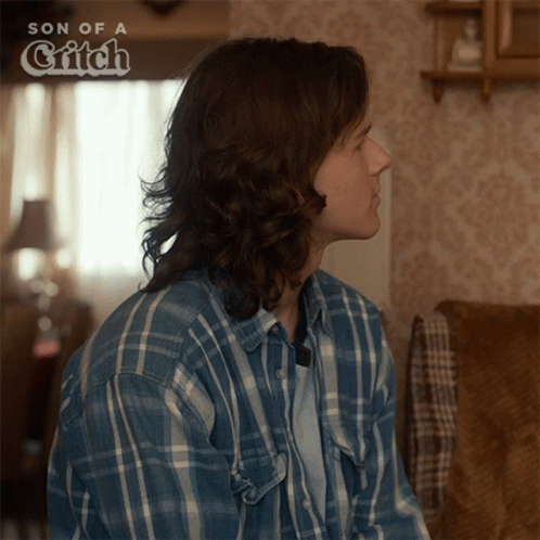 Man in Plaid Shirt Sitting on Couch Son of a Gritch
