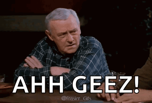 Man In Plaid Shirt Sitting With Arms Crossed Saying Ahh Geez GIF