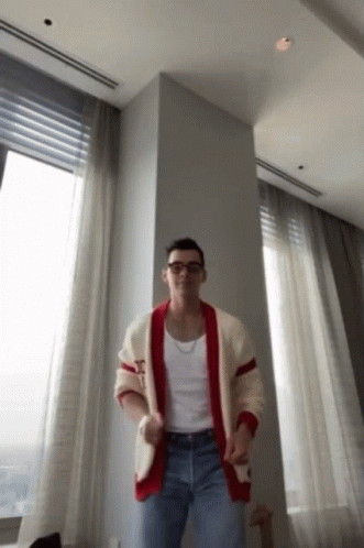 Man In Plaid Shirt Sitting With Hands Up GIF