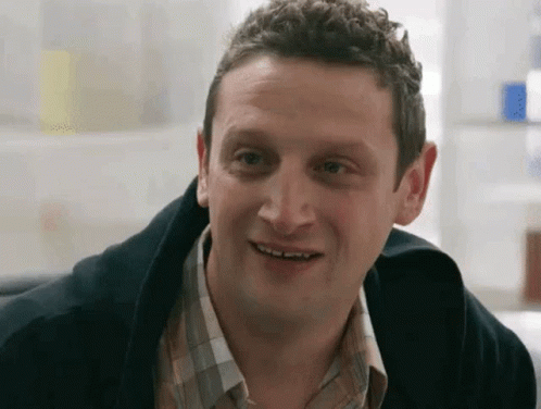 Man in Plaid Shirt Smiling at Camera