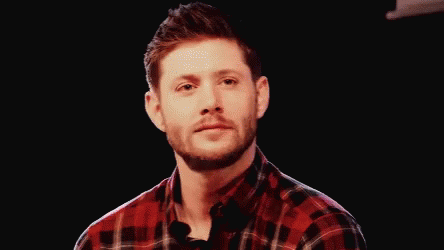 Man In Plaid Shirt Smiling Holding Microphone GIF