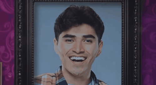 Man in Plaid Shirt Smiling in Frame