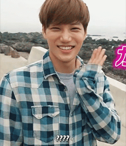 Man in Plaid Shirt Smiling Says ??