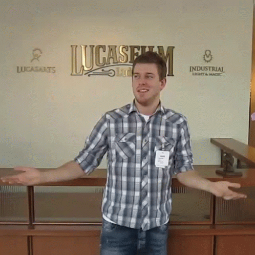 Man in Plaid Shirt Standing in Front of Lucasfilm Sign