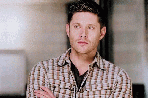 Man In Plaid Shirt Standing With Arms Crossed Looking Away GIF