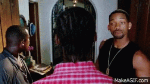 Man in Plaid Shirt Talking to Another Man
