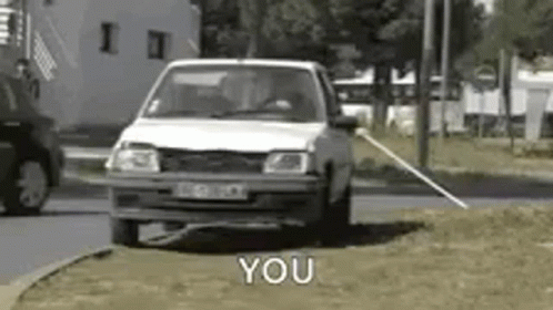 Man in Plaid Shirt Talking to Another Man in Car