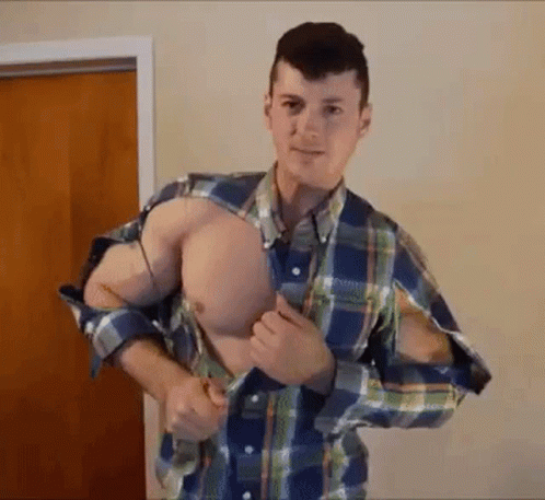 Man In Plaid Shirt With Holes Standing At Wooden Door GIF