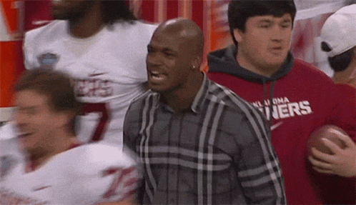 Man in Plaid Shirt with Oklahoma Holding Football