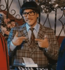 Man in Plaid Suit Giving Thumbs Up