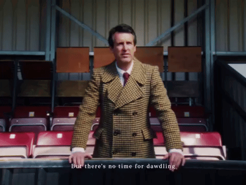 Man in Plaid Suit in Stadium But There's No Time for Dawdling