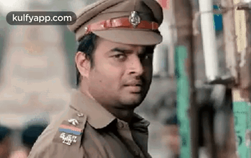 Man in Police Uniform Looking at Camera