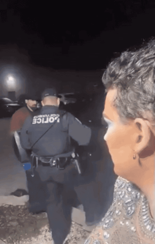 Man in Police Uniform Talking to Woman in Dress