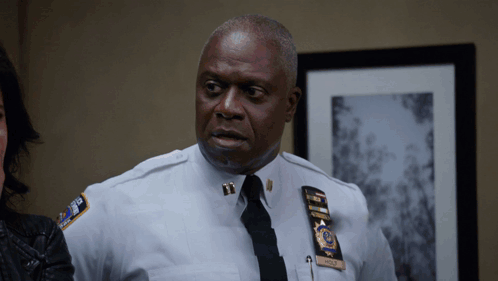 Man in Police Uniform With Wolf Name Tag