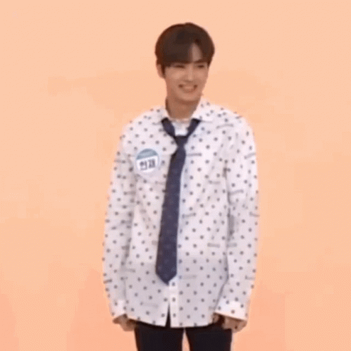 Man In Polka Dot Shirt And Tie Holding Hula Hoop GIF