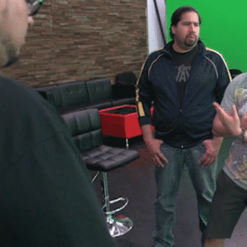 Man In Polka Dot Shirt And Tie Holding Hula Hoop GIF