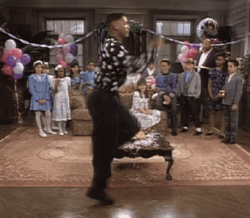 Man in Polka Dot Shirt Dancing in Front of Crowd