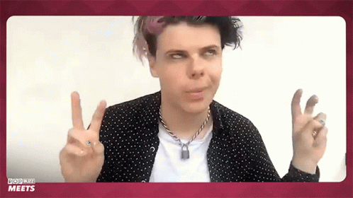 Man in Polka Dot Shirt Giving Peace Sign