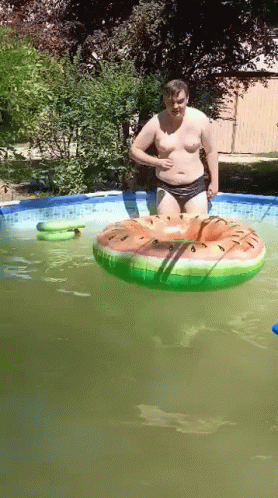 Man in Pool with Watermelon Float
