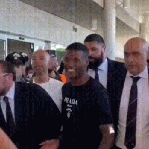 Man in Prada Shirt Surrounded by Suits and Ties