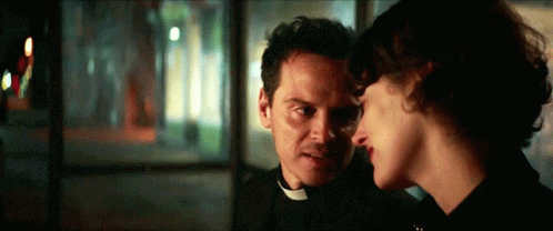 Man in Priest Collar and Woman Looking at Each Other