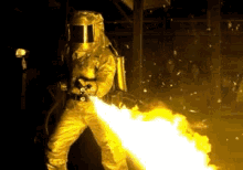 Man In Protective Suit Spraying Fire GIF