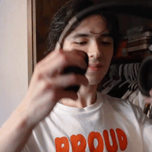 Man in Proud Shirt Holding Something