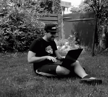 Man in Puma Hat Using Laptop