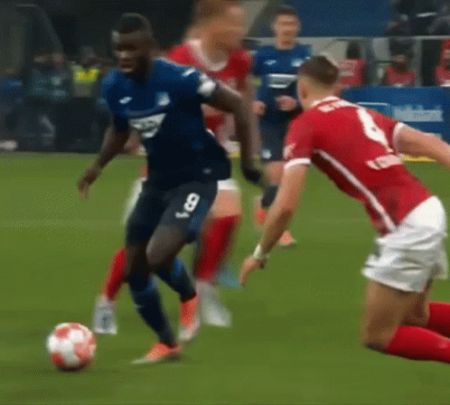 Man In Puma Sweatshirt Kicking Soccer Ball On Field GIF