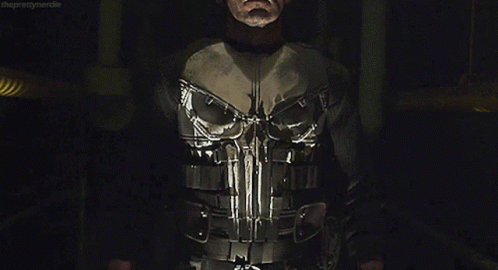 Man in Punisher Costume in Dark Room