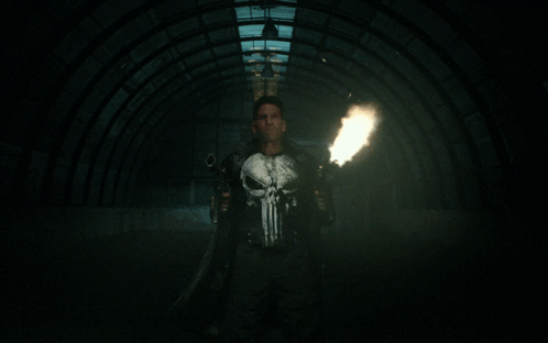 Man in Punisher Shirt Holding Guns