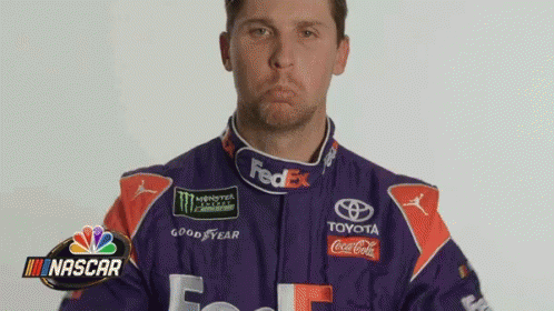 Man in Purple and Orange Racing Suit Making Face