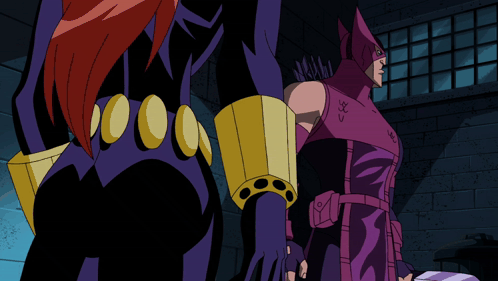 Man In Purple Costume With Bow And Arrow Next To Woman In Black Suit GIF