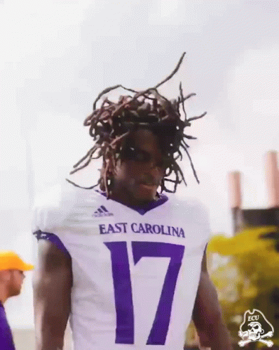 Man in Purple ECU Shirt Holding Up Fist