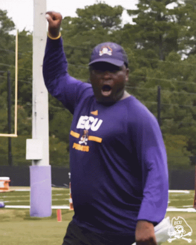 Man in Purple ECU Shirt Holding Up Fist