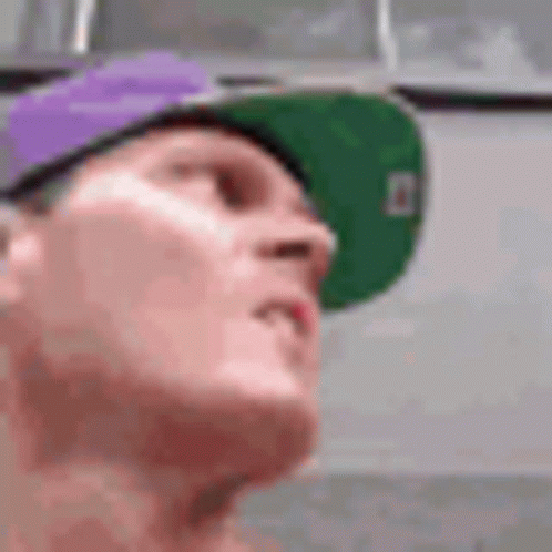 Man in Purple Hat and Green Hat