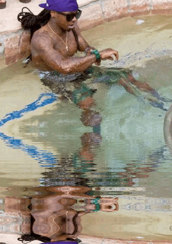 Man in Purple Hat Sitting in Swimming Pool