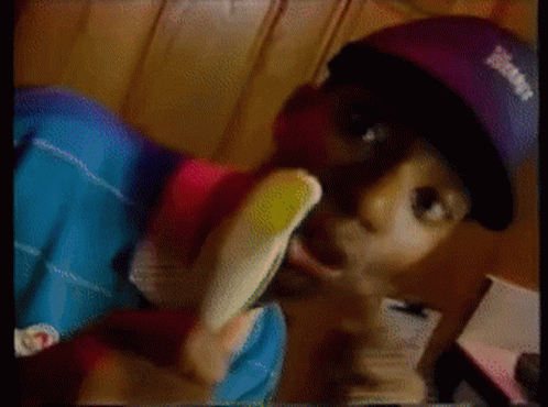 Man in Purple Hat With Eamf Eating Banana