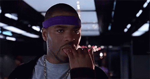 Man In Purple Headband And Chain Licking Fingers GIF