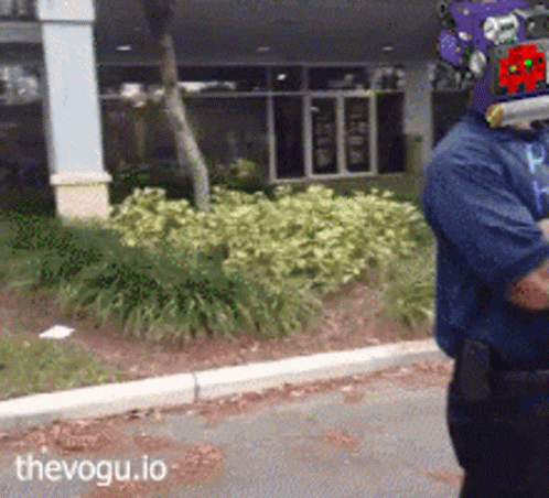Man in Purple Helmet Walking Down Street With thevogu.io