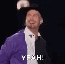 Man In Purple Jacket And Black Hat Smiling Says Yeah GIF