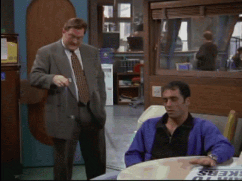 Man in Purple Jacket at Workers Sign